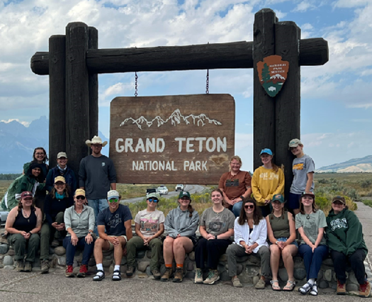 Group photo in front of Grand Teton National Park sign.